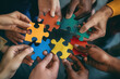 © VikaKa - A group of diverse hands holding colorful puzzle pieces that fit together perfectly, symbolizing the idea that each person's unique qualities can contribute to an overall whole or team success
