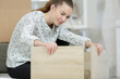 © auremar - capable young lady assembling flatpack furniture