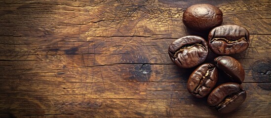 Wall Mural - Retro vintage style coffee bean on wood background with a filter effect creating a captivating copy space image