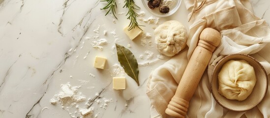 Poster - Top view of ingredients for making pelmeni ravioli and dumplings including dough rosemary a rolling pin canvas thread butter and a bay leaf on a light background with a toned effect allowing for copy