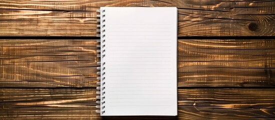 Aufkleber - Top view of a notebook paper on a wooden surface ideal for business and education concepts with ample copy space image