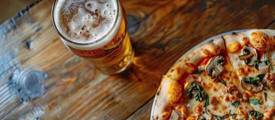 Poster - Scrumptious pizza topped with a mix of cheese and mushrooms served with beer on a table with copy space image