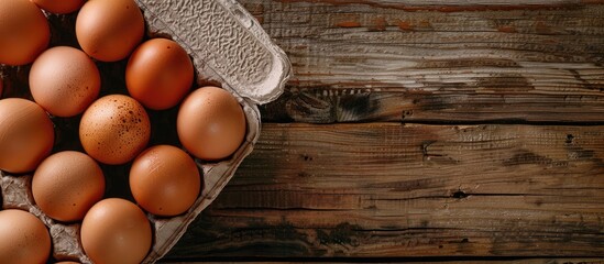 Poster - An open egg carton containing fresh brown chicken eggs with available copy space in the image