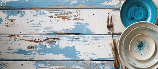 Leinwandbilder - Overhead shot of blue dining set on aged white wood Photo with copy space image