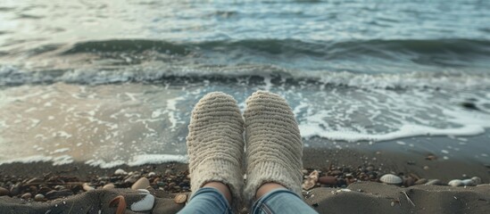 Poster - Legs wearing slippers by the seaside with a scenic background perfect for copy space image
