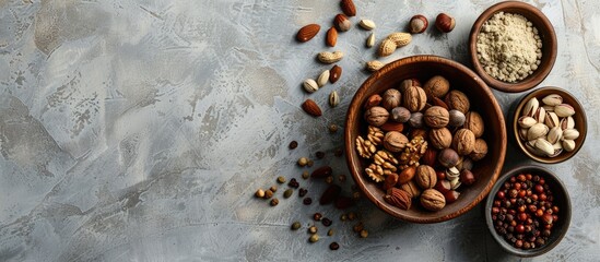 Canvas Print - Top view of various spices and nuts in a bowl on a textured light gray table with room for text in the image. Creative banner. Copyspace image