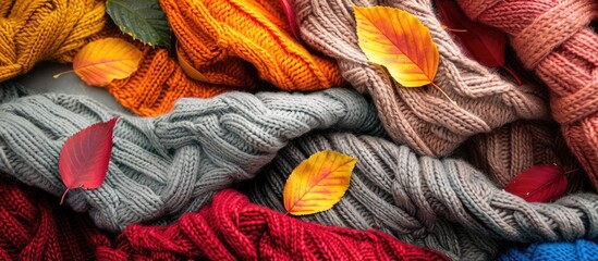 Poster - In fall cozy sweaters are complemented by colorful leaves in a beautifully intertwined display capturing the essence of the season in a remarkable copy space image