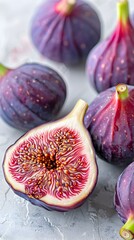 Poster - Freshly Cut Open Purple Figs with Detailed Sweet Seeds on Gray Concrete Background