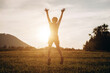 © Yura Yarema - Dreaming happy child outstretching arms up on background mountains. Preteen girl victory raising hands up on rural field at warm sunset, enjoying rest at nature. Freedom emotion and flying thoughts