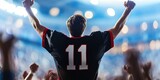 Fototapeta Londyn - fan cheering in stadium, blank black football jersey, red trim, white number 