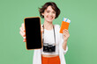 © ViDi Studio - Traveler woman wear casual clothes hold passport ticket use blank screen mobile cell phone isolated on plain green background. Tourist travel abroad in free time rest getaway. Air flight trip concept.