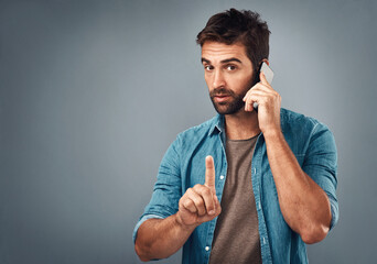 Aufkleber - Man, phone call and finger for quiet in studio portrait, talk and emoji for privacy in conversation. Male person, mockup space and wait for communication, confidential chat and icon to stop noise