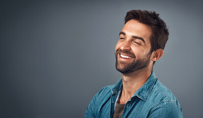 Poster - Happy, mockup space and man in studio with positive attitude, confidence and pride. Fashion style, trendy clothes and isolated person with joy, cheerful and excited expression on gray background
