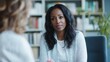 © indyntk - Black therapist in a serene office setting, using empathetic communication and active listening with clients