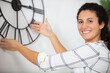 © auremar - mature woman hanging clock on the wall