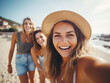 © Llama-World-studio - Group of happy women photographing and waving on the beach