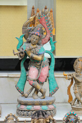 Wall Mural - Bronze statue of Krishna decorated with stones.