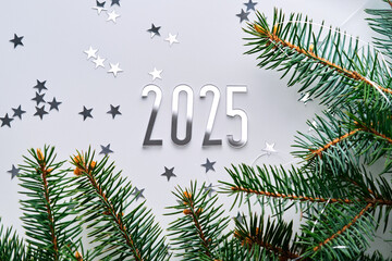 Wall Mural - abstract light christmas background with stars and a christmas tree with the year number 2025.