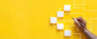 © Mahmud - Business process and workflow automation with flowchart. Hand-holding wooden cube block arranging processing management on a yellow background design