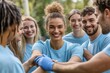 © fotofabrika - A Group of Young Volunteers Smiling and Shaking Hands in a Park During a Community Service Day