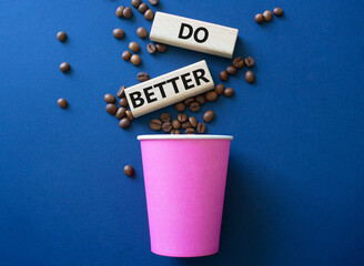 Do better symbol. Wooden blocks with words Do better. Beautiful deep blue background with coffee cup. Business and Do better concept. Copy space.