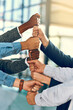 © JordaanExams/peopleimages.com - Business people, hands and fist stack with teamwork for employee solidarity, inclusion and equality in workplace. Diversity group, pile and collaboration for staff support, synergy and cooperation
