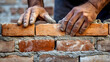 © Jess rodriguez - bricklayer putting building blocks of a house with his hands