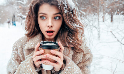 A woman with a coffe. A surprised woman