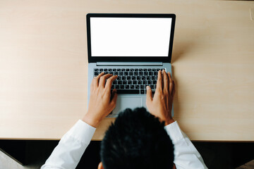 Wall Mural - Business person or office worker using laptop computer while sitting at desk. uds