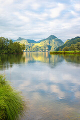 Wall Mural - calm swiss lake alpnach with beautiful sunlit mountains in the background