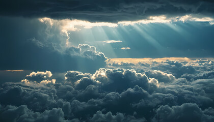 aerial view of dark sky background above rain clouds and sun is peeking out. rainstorm, crepuscular rays, serene nature scene.