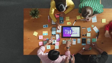 Top view of software developer writing idea about Ux ui design for mobile phone interface. Programmer brainstorm and planning wireframe prototype by looking tablet display smart software. Convocation.