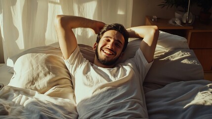 handsome happy young arab guy waking up in the morning sitting on bed and stretching after good slee