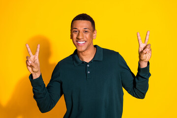 Sticker - Portrait of nice young man demonstrate v-sign wear pullover isolated on vibrant yellow color background