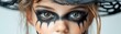 © TEERAWAT - A close-up portrait of a child wearing creative makeup and a witch hat, capturing the essence of Halloween excitement.