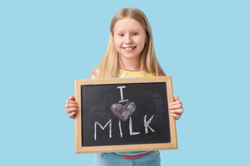 Sticker - Little girl holding blackboard with text I LOVE MILK on blue background