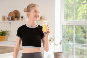 Sticker - Sporty young woman with healthy smoothie in kitchen