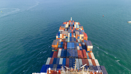 Wall Mural - stern view Cargo container ship carrying container and running in the ocean near international container port customs shipyard sea port concept smart logistic service. transportation