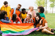 © Vane Nunes - People celebrate rainbow party holding gay LGBTQ flag in summer day at park city. Focus on black woman. Diversity concept