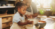 © AzeemudDeen/peopleimages.com - Learning, child and black woman in kitchen for baking, recipe or cake ingredients at home. Girl, development and mother at counter for growth, teaching or fun activity for making dough for cookies