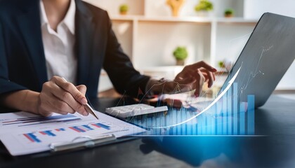 Poster - Businesswoman analyzing financial data with graphs on laptop while taking notes on paper documents in a modern office environment