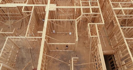 Wall Mural - Unfinished wooden frame of apartment building ready for mounting roof beams under construction. Development of residential housing in American suburbs. Real estate market in the USA.