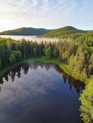 Serene Mountain Lake at Dawn: Aerial View of Misty Waters Surrounded by Pine Forests. Tranquil Reflection Creates Perfect Mirror Image in Crystal-Clear Lake, Ideal for Nature Tourism and Summer Vacati