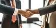 © dakinya - Close-up of a handshake between two business professionals, formal attire, partnership, agreement, business deal, corporate setting, successful negotiation, trust, cooperation, professionalism