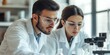 © dakinya - Two scientists wearing safety glasses working together in a laboratory, focused expressions, research, teamwork, science experiment, modern lab environment, collaboration, analyzing results