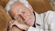 © EgonDorr - An elderly Caucasian man peacefully sleeping on a cozy sofa, showcasing the beauty of relaxation and serenity in his mature years.