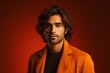 © MediaRaw - A man with long hair is wearing an orange jacket
