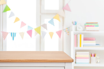 Wall Mural - Empty wooden tabletop with blurred decorated window and book shelf background