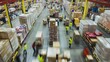 © arhendrix - Busy warehouse interior with workers moving pallets and goods, showcasing logistics and inventory management in a large distribution center.