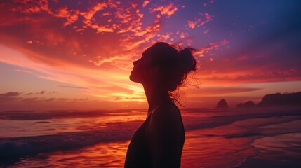 Wall Mural - radiant woman embracing freedom silhouetted against vibrant sunset beach sky